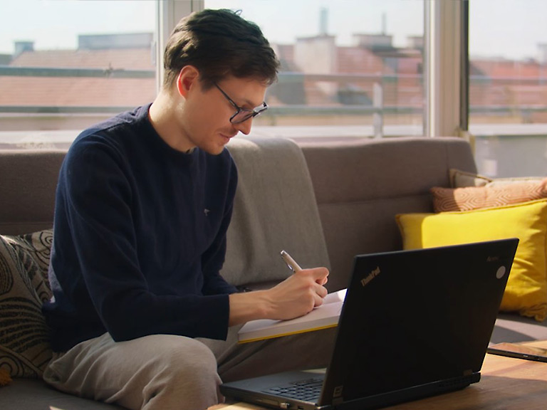 Employee at work writing something on a notepad